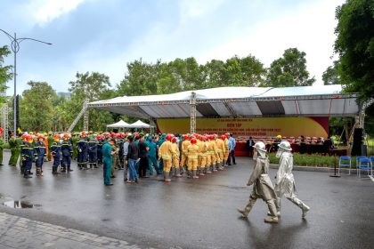Bombeiros uniformizados reunidos ao ar livre durante uma atividade de segurança e treinamento.
